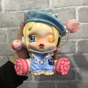 Colored doll figurine with butterfly motifs